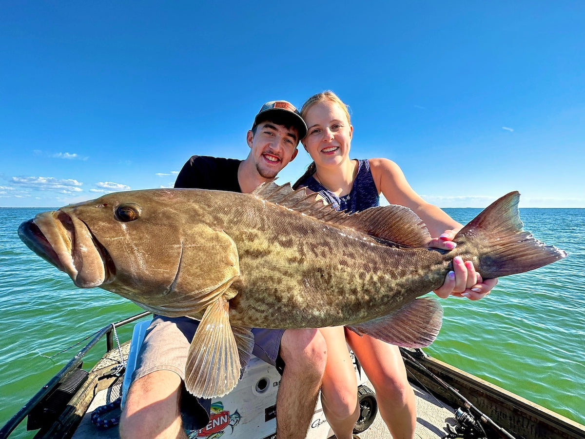 Couple holding big Grouper on Fishing Charter
